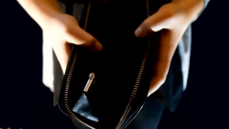 a teenage girl holds a wallet, opens it and there is no money in it, footage suitable for telling about poverty, survival and work problems