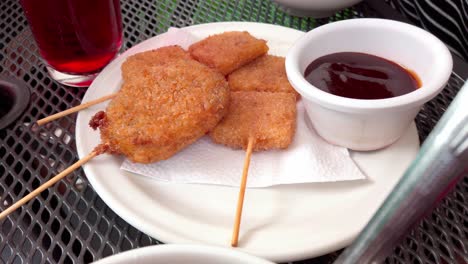 golden fried cheese sticks with dipping sauce, served on a plate