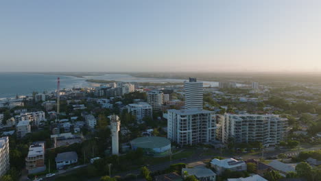 4K-Drone-Flyover-Sunshine-Coast-Oceanview-Resorts-And-Cityscape-At-Sunset,-4K-Aerial