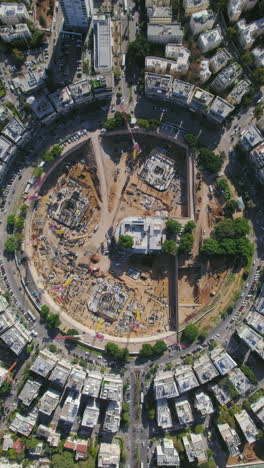 vertical static shot over kikar (square) hamedina impressive project construction - tel aviv, israel