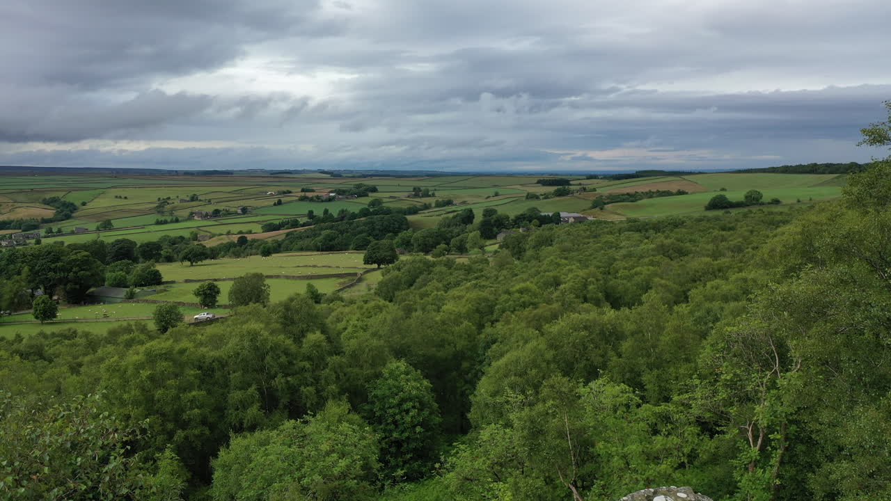 Aerial flight starting behind the Druid's writing desk at Brimham rocks in North Yorkshire and flying up looking out to the landscape