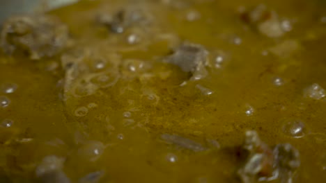 slow-motion capture of bubbling meat curry, tantalizingly prepared, evoking the essence of gourmet dining and culinary delight