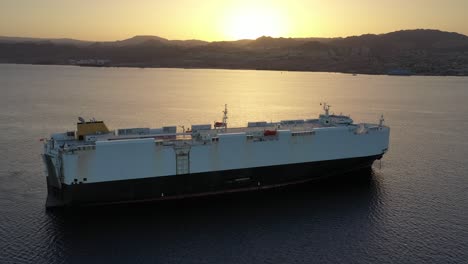 car carrier ship at sunset in port