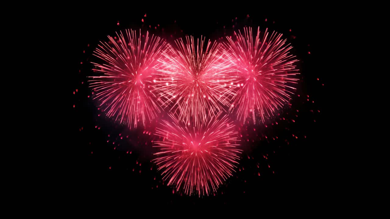 Vista aerea di fuochi d'artificio a forma di cuore che esplodono in un vivido rosa su un cielo nero