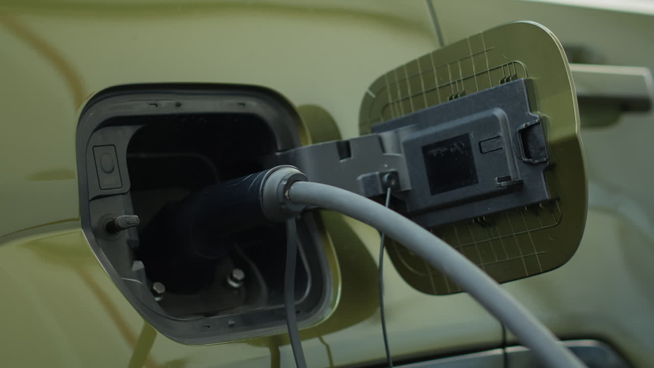 Closeup Of Zero Emission Ev Vehicle Connected To Charging Dock