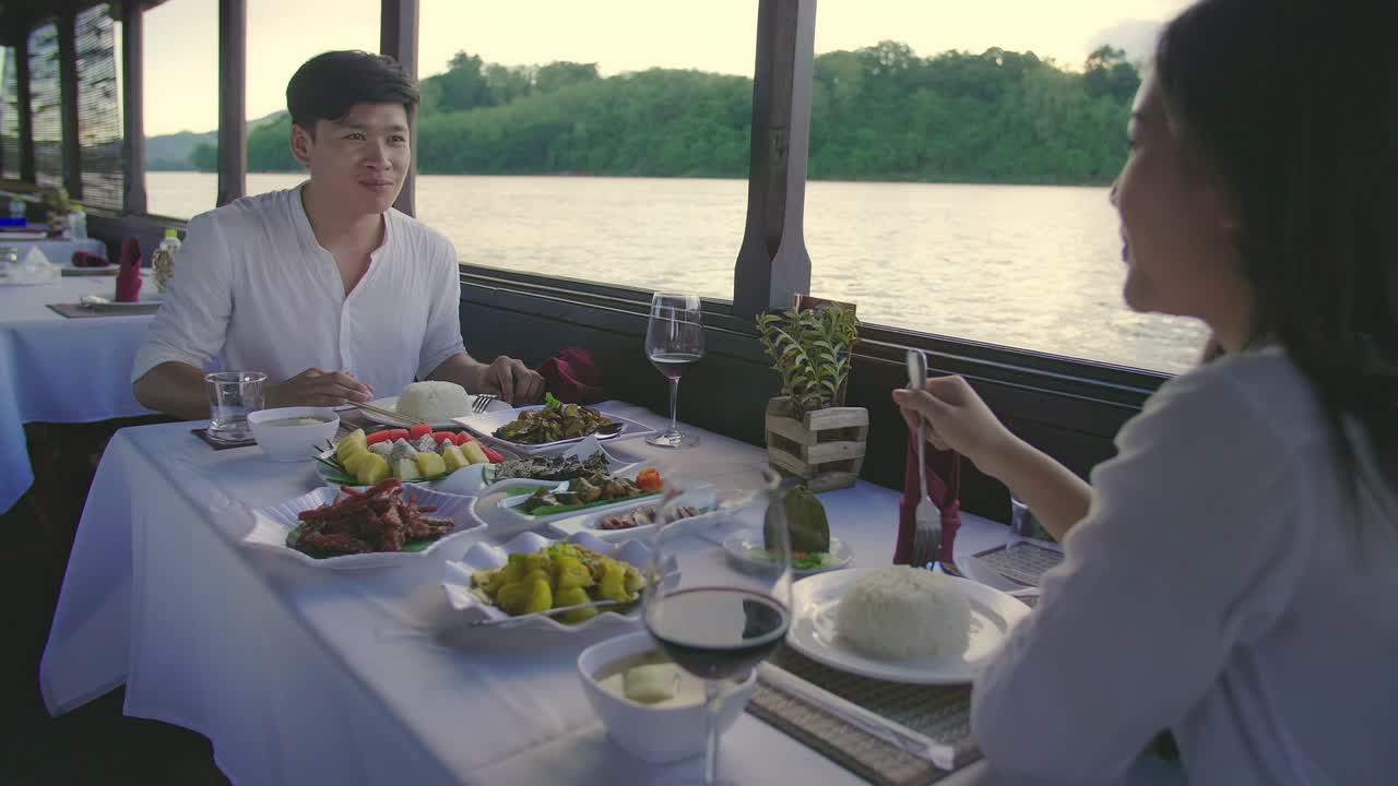 Couple enjoying a river cruise dinner
