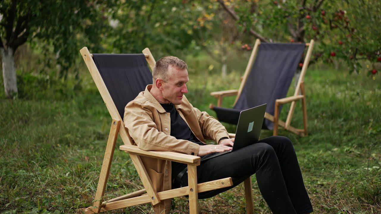 hombre trabajando en una computadora portátil al aire libre