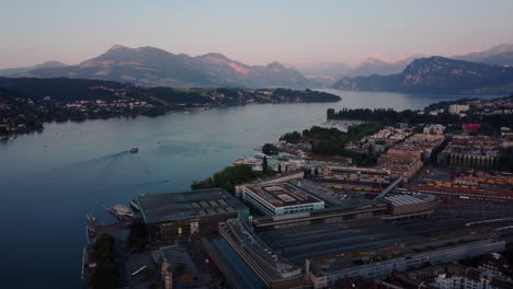 aerial overview of the vierwaldstättersee and train station and harbor of lucern after sunset