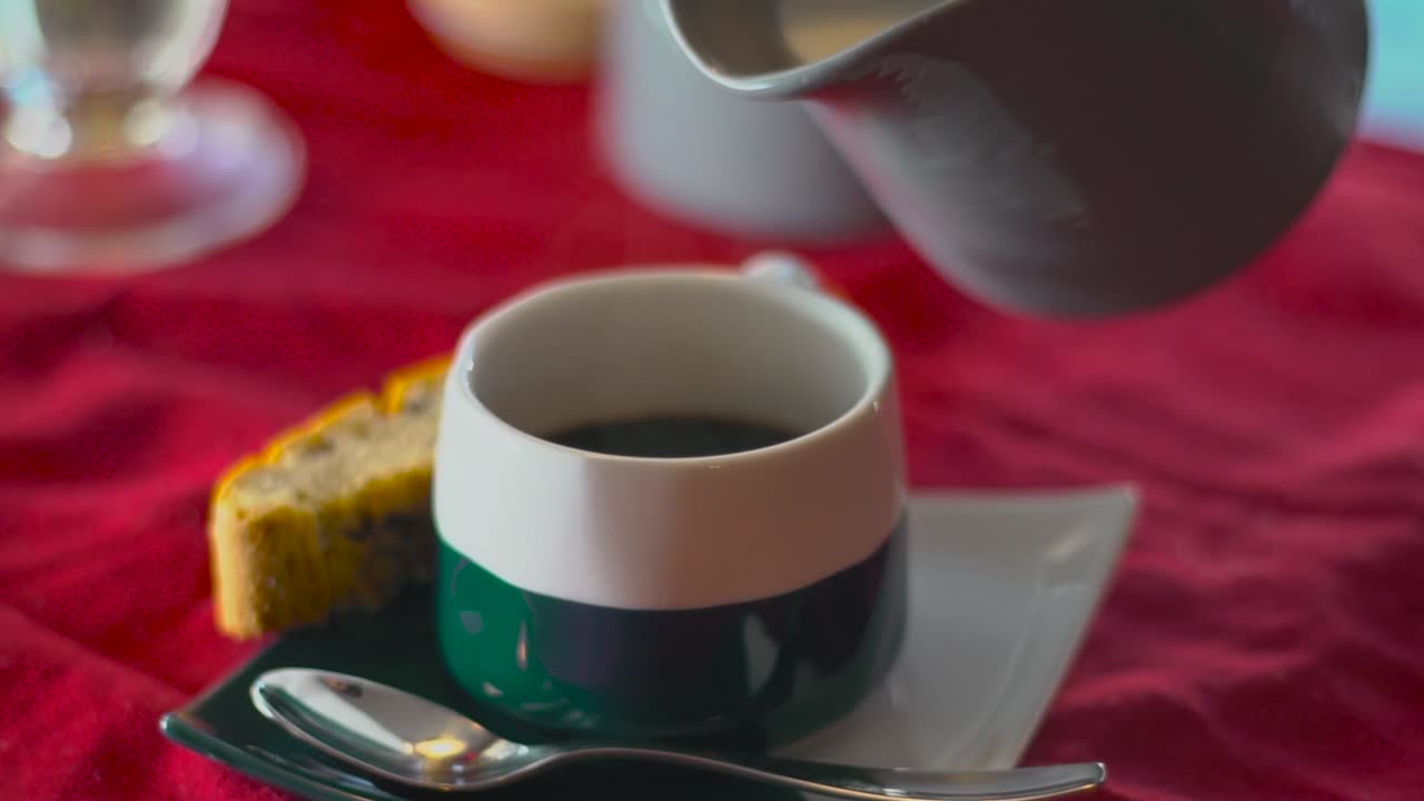 una persona vierte crema en expresso