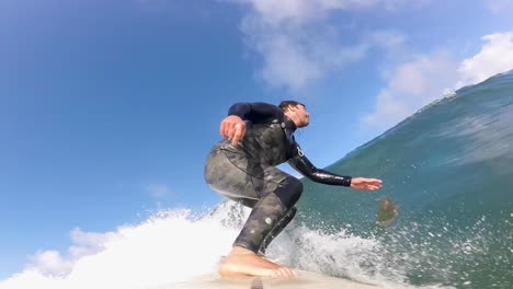 surfer is jumping above wave while surfing