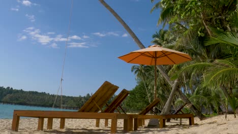 beach beds with umbrella on white sandy beach