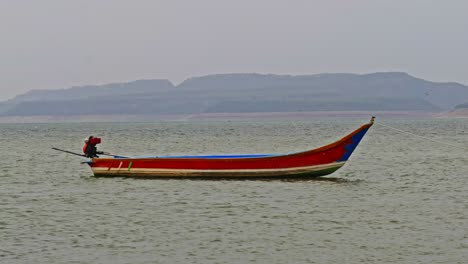 fishing boat waving in krishna river and hill mountain at vizag colony, nagarjuna sagar backwater, azmapur, telangana, andhra pradesh, india. day time, zoom in, 4k.