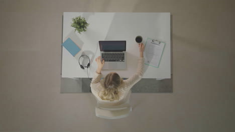 woman ending work, closing laptop lid