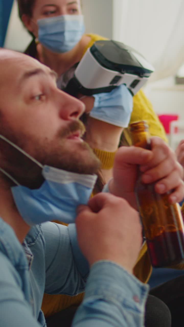 Vertical video: Young woman experiencing virtual reality playing video games