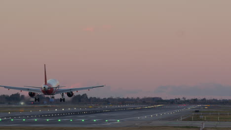 airplane landing at sunset