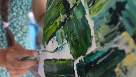 mujer pintando arte abstracto con un cuchillo de paleta
