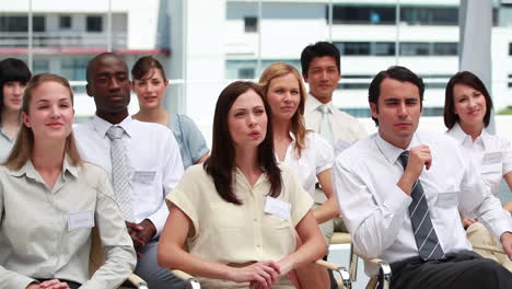 People-raising-their-hands-while-sitting