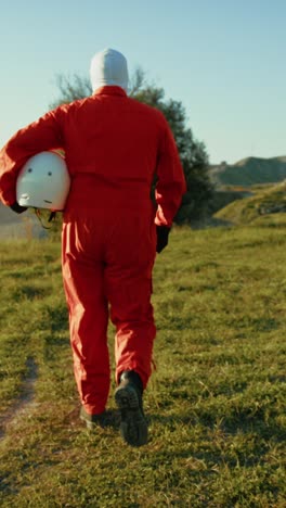 astronaut walks in the meadow of earth before his departure for space