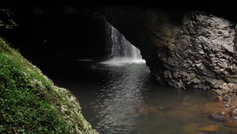 View-of-the-waterfall-in-Natural-Bridge,-Springbrook-National-Park,-Gold-Coast-Hinterland,-Australia