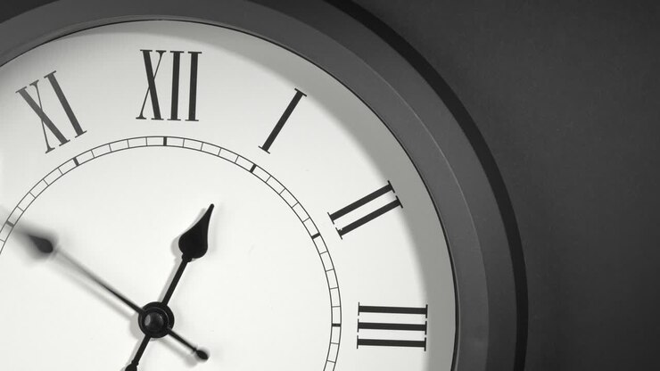 Latin Clock Face in Time Lapse on Dark Grey Wall
