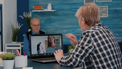 middle aged woman talking video conference with children