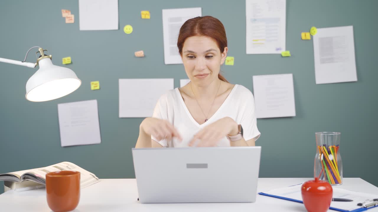 The woman who likes the application on the laptop is happy.