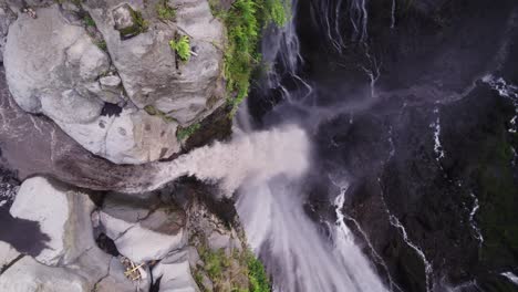 glidik river falling into rock canyon of tumpak sewu waterfall, top down