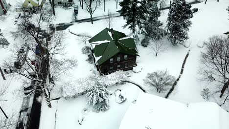 Side-view-of-Snowy-suburban-house-Drone-shot