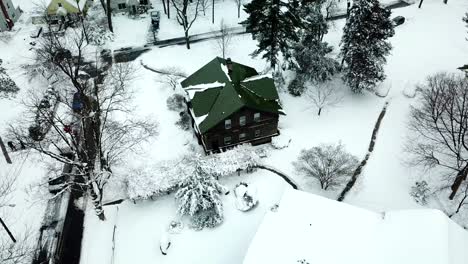 side view of snowy suburban house drone shot