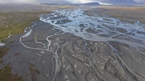 Drone-shot-of-glacier-rivers-that-come-from-Sólheimajökull-Glacier-in-Iceland