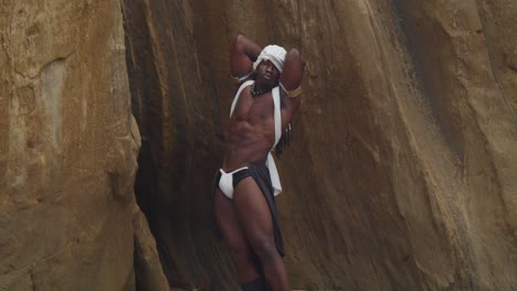 on the sandy shore, a muscular male cosplayer with dark skin.