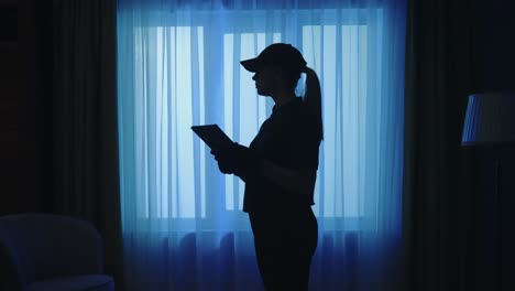 woman using tablet at night