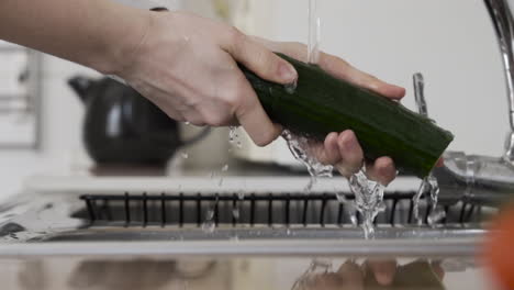 close shot as washing vegetable with water at the sink health care with hygiene