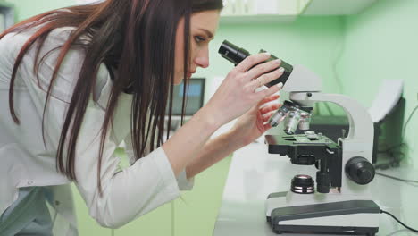 scientist using a microscope in a laboratory