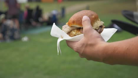 close up on a burger being carried during an event