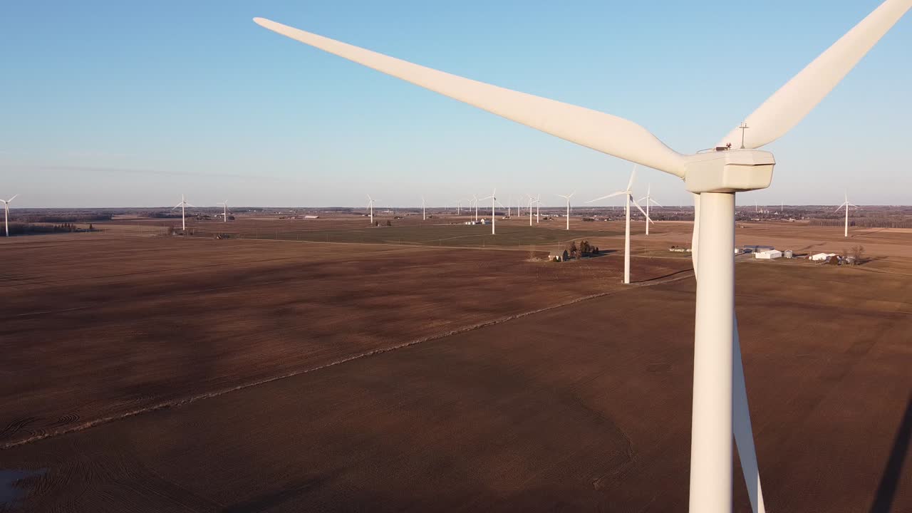 Wind Turbines In The Middle Of The Agricultural Farm In Ubly, Michigan Against The Blue Sky.-closeup shot