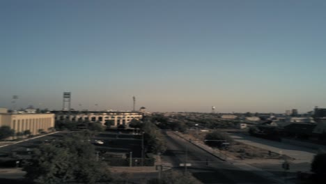 360 view, urban cityscape downtown buildings pan right during sunset