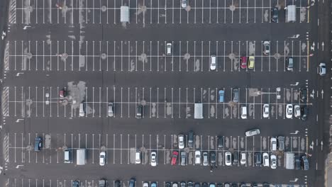 aerial: cars driving in a parking lot during quarantine