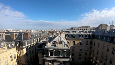 Haussman-style-Rooftops-in-Paris-near-Montmartre-on-a-sunny-morning-with-Sacre-coeur-Basilica-far-away-,-Locked-Time-lapse-shot