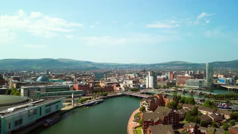 wide rising aerial gv of belfast city centre, northern ireland, uk on a bright and sunny day. produced in 4k, 60fps and with rec709 color