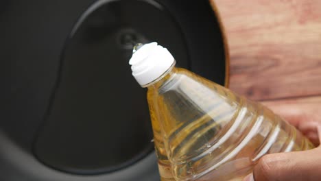 pouring oil into a pan