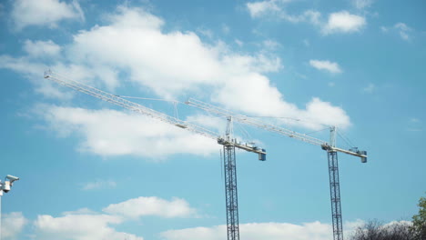 Construction-cranes-against-a-blue-sky