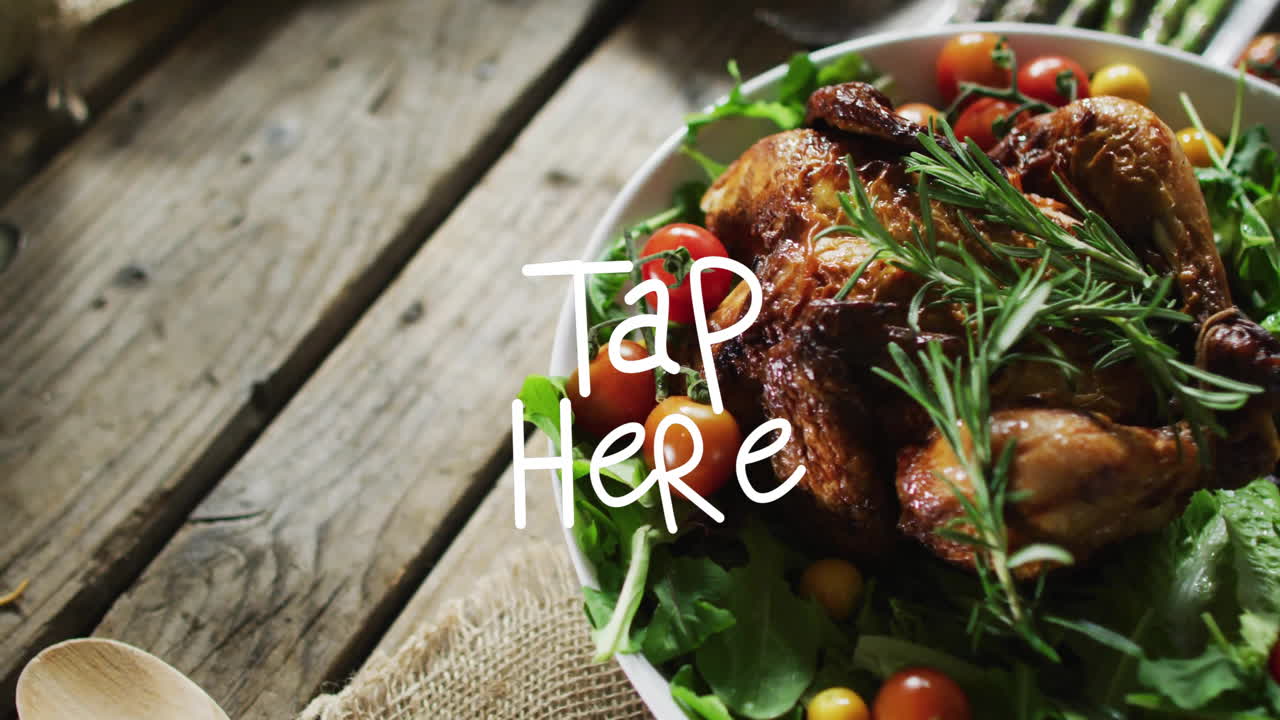 Tap Here text animation over roasted chicken with vegetables on wooden table
