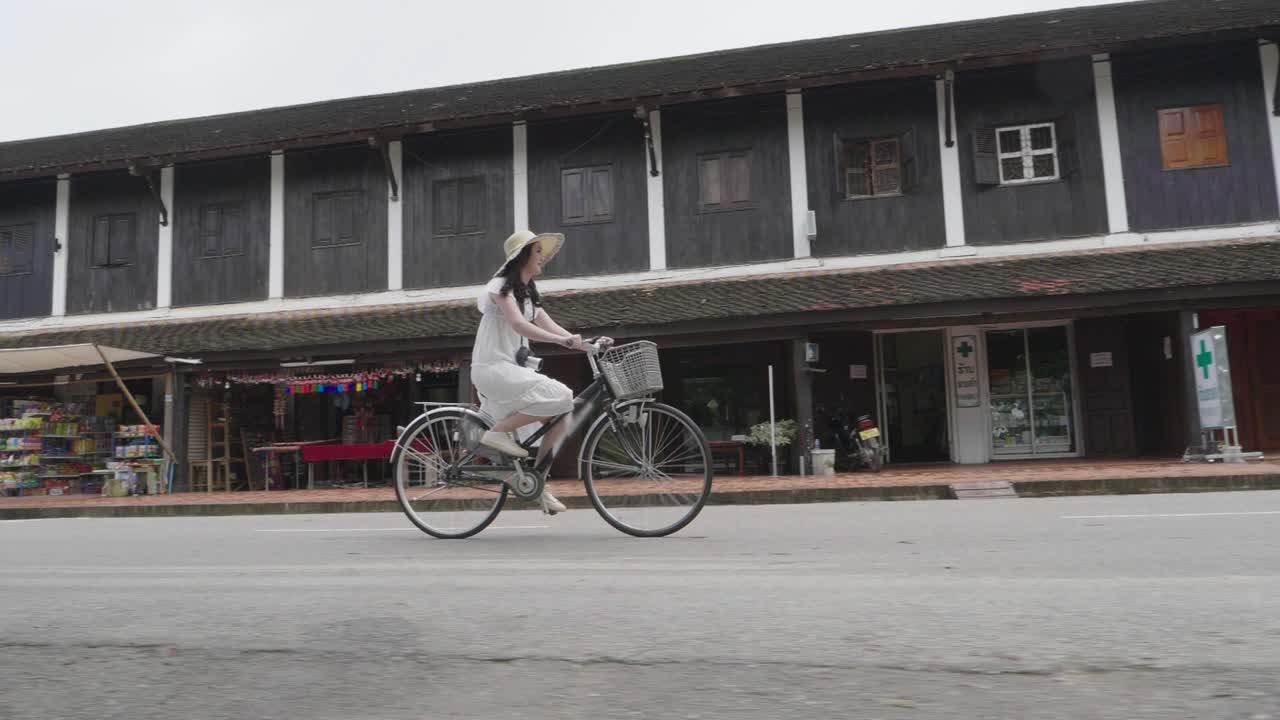 Beautiful Tourist Girl Cycling To Visit Luang Prabang, Slow Motion