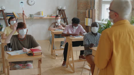 multiethnic students in masks on lesson during covid-19 outbreak