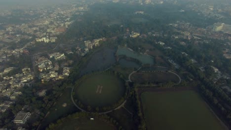 Bombay,-India,-Aerial-flight-going-to-the-horse-riding-ground-and-trraining-areas,-a-pond-with-the-parks,-top-city-view,foggy-weather-of-the-city