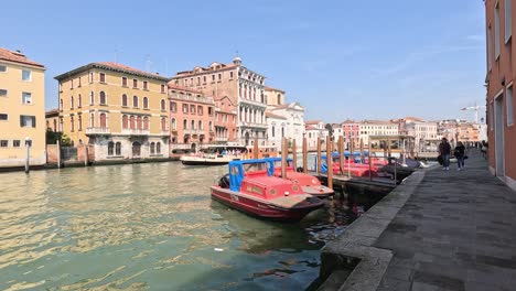 boats docked along a canal in venice