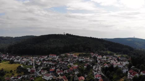 Aerial-flight-of-captivating-view-of-Wilhelmsfeld-town-on-sunny-and-cloudy-day,-Germany