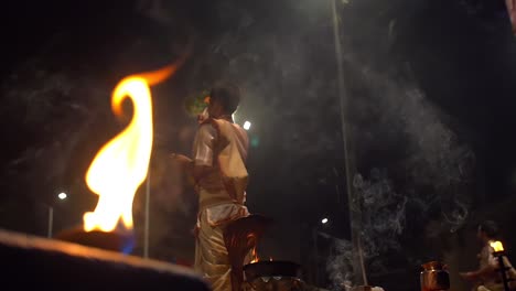 men waving ceremonial ganga aarti fans