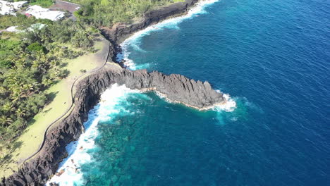 aerial view over the lava rock formation of cap mechant and the coastline of reunion island